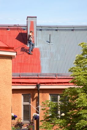 Roof painting in Newhall, CA by M & M Developers Inc..